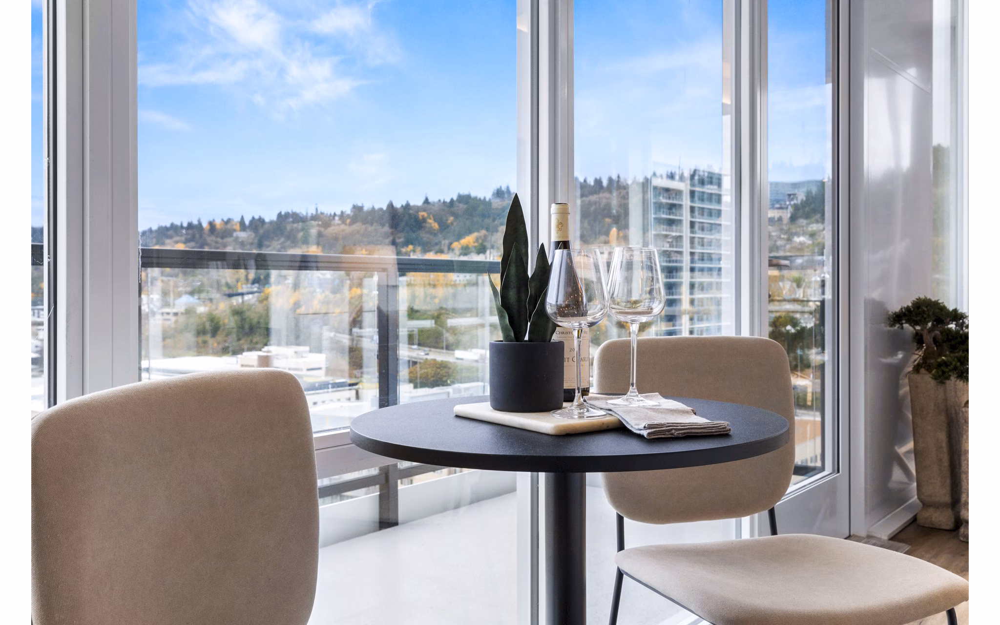 Dining room with modern furnishings at Willamette Tower Apartments featuring sleek table and chairs in Greystar's luxury apartments