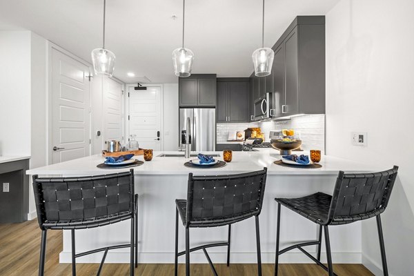Modern kitchen with stainless steel appliances in Willamette Tower Apartments