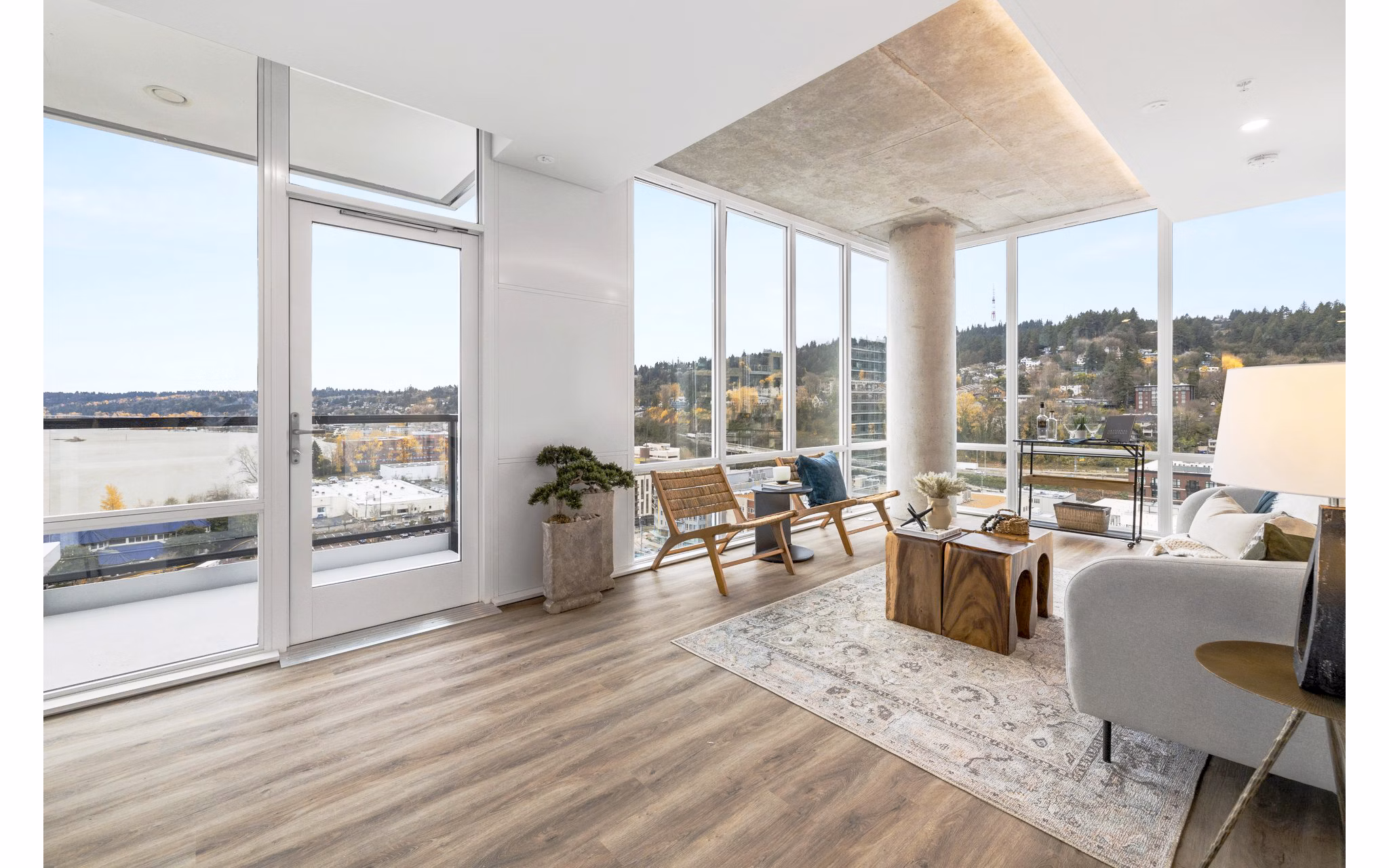 Modern living room with large windows and city views at Willamette Tower Apartments