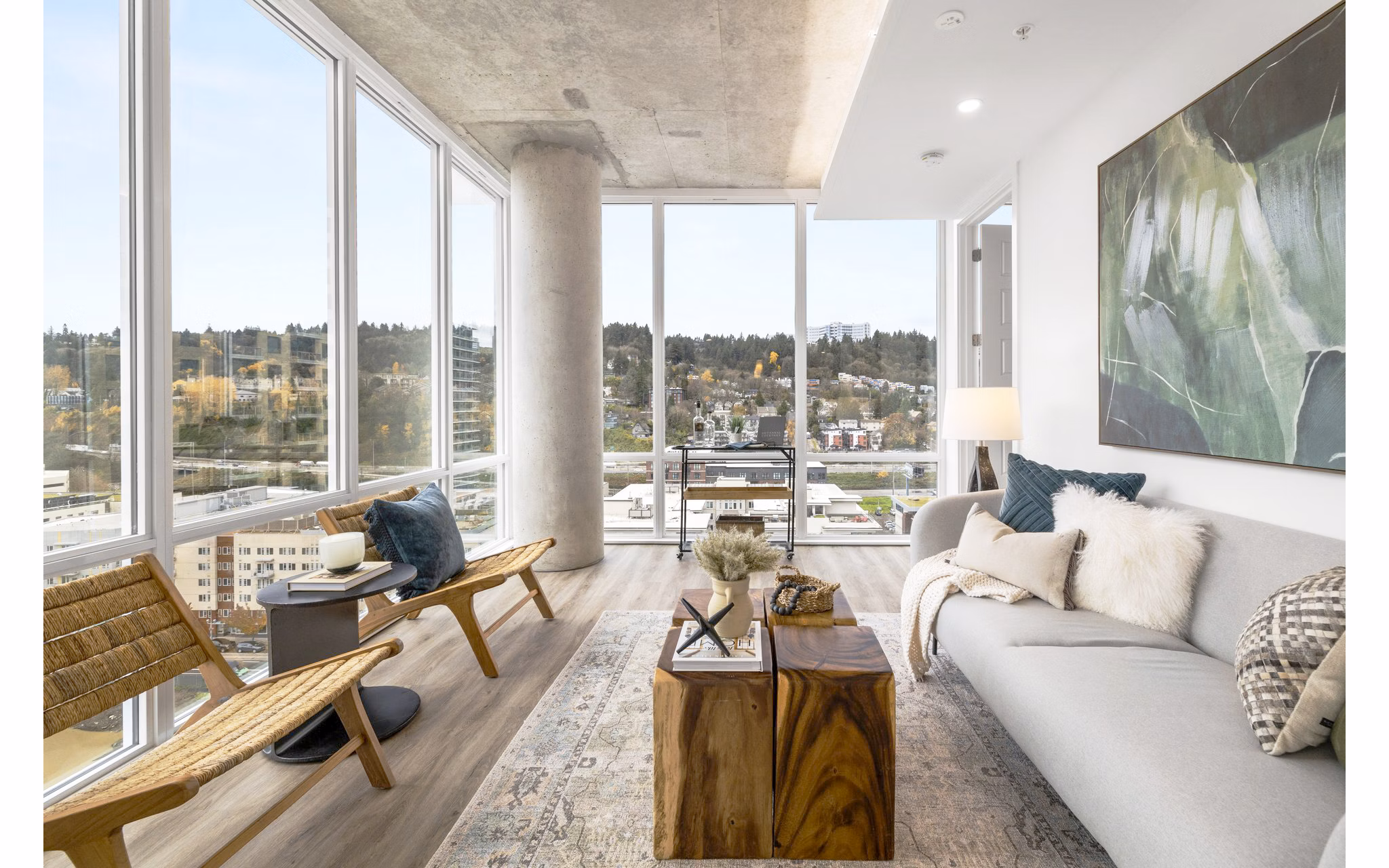 Modern living room with sleek furniture and large windows at Willamette Tower Apartments