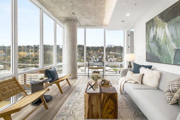 Modern living room with sleek furniture and large windows at Willamette Tower Apartments