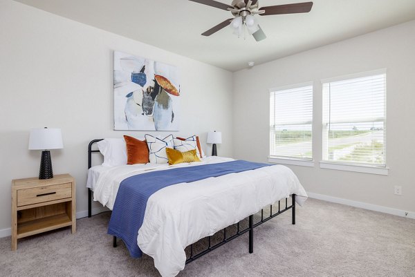 Spacious bedroom with large windows at Caso University Heights Apartments, luxury living options in a vibrant community