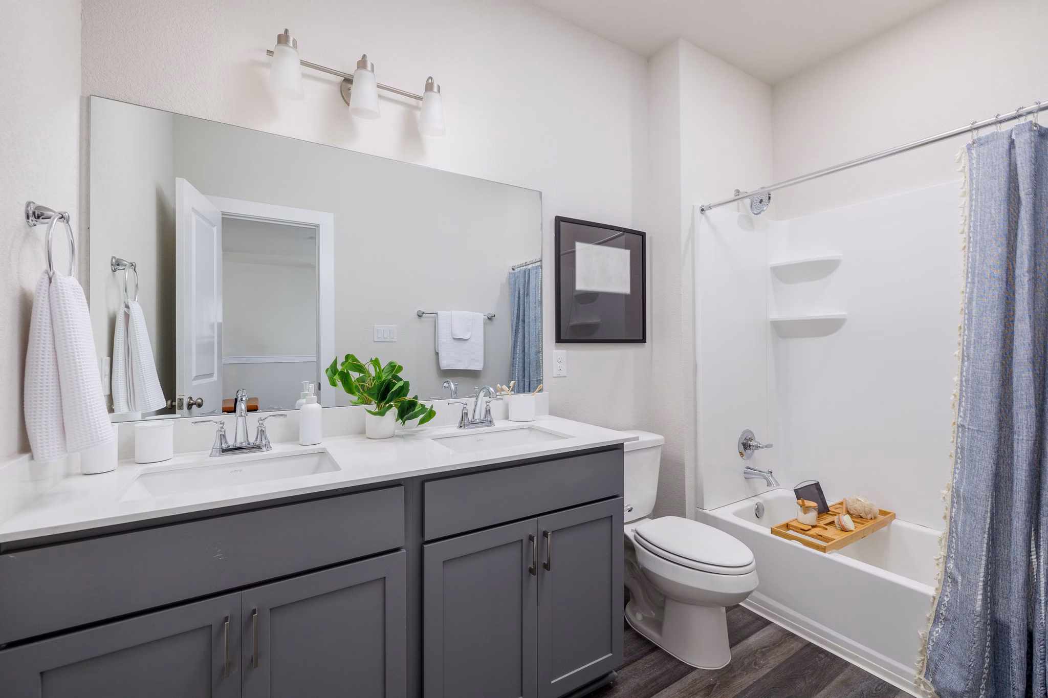 Modern bathroom featuring sleek fixtures and marble countertop at Caso University Heights Apartments