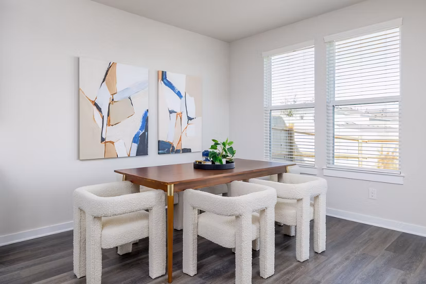 Dining area with modern decor at Caso University Heights Apartments: Elegant setup with wooden table and pendant lighting