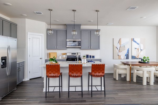 Modern kitchen with stainless steel appliances in Caso University Heights Apartments