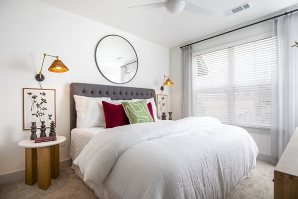The Madison at City Place: Elegant bedroom with cozy lighting and modern decor