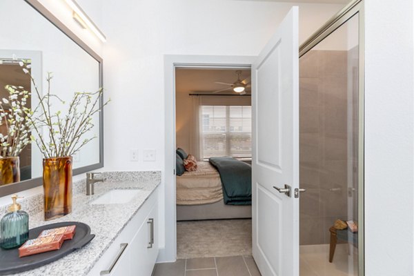 Modern bathroom with marble countertops and spacious shower at The Madison at City Place Apartments