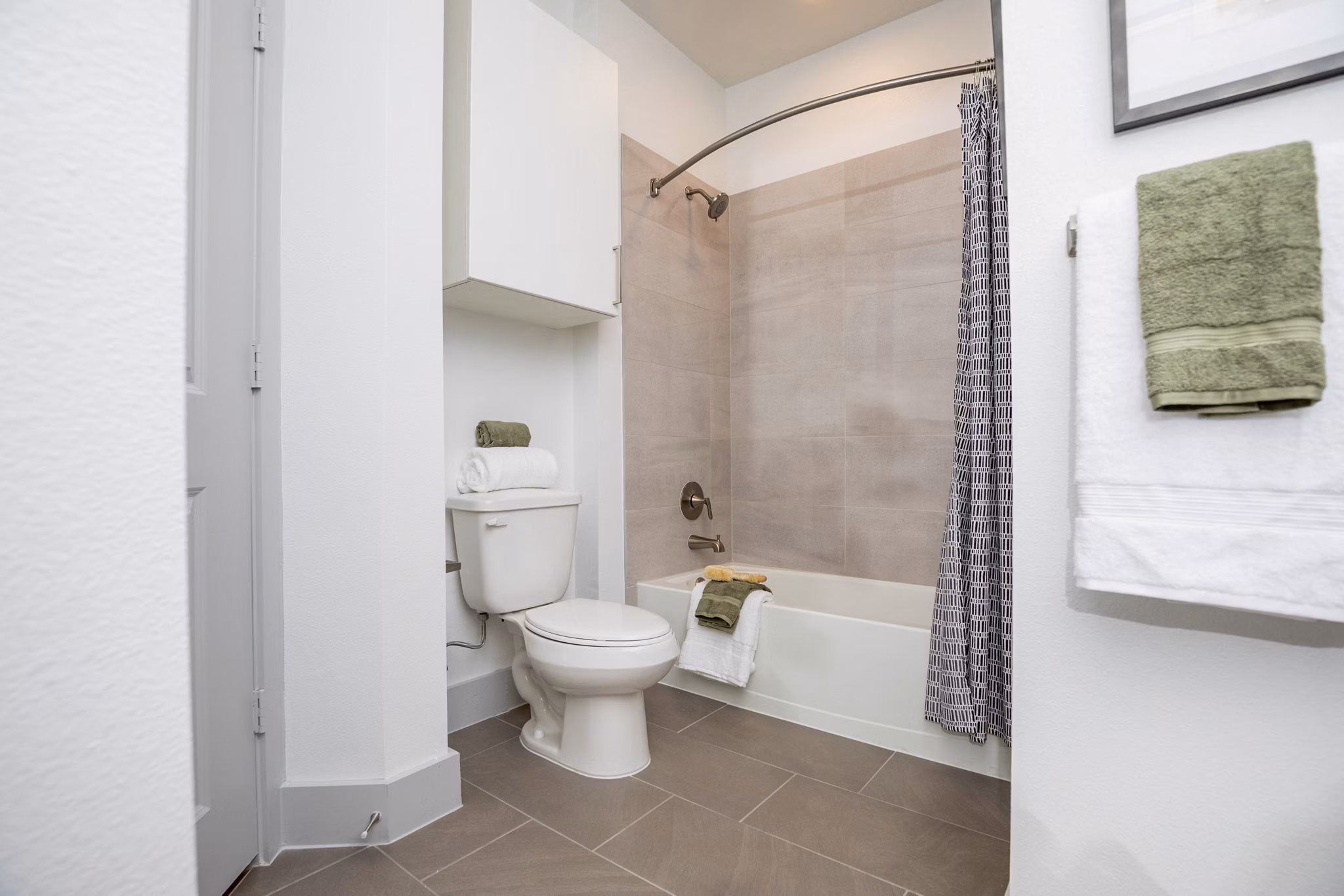 Modern bathroom with sleek vanity and soaking tub at The Madison at City Place Apartments