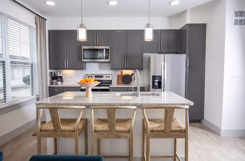 Modern kitchen with stainless steel appliances at The Madison at City Place Apartments, a Greystar luxury community