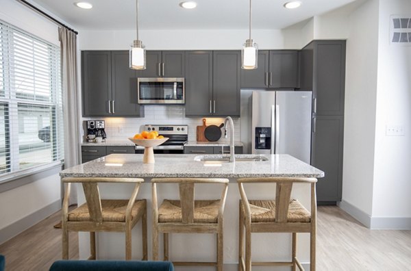 Modern kitchen with stainless steel appliances at The Madison at City Place Apartments, a Greystar luxury community