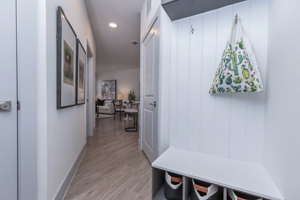 Hallway entrance featuring contemporary design and modern lighting at The Madison at City Place Apartments