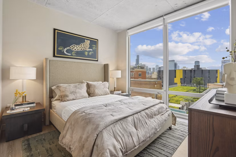Cozy bedroom featuring modern decor and large windows in Spoke Apartments, Chicago