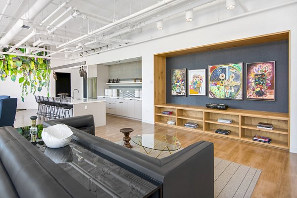 Clubhouse featuring modern seating and large screen TVs at Spoke Apartments