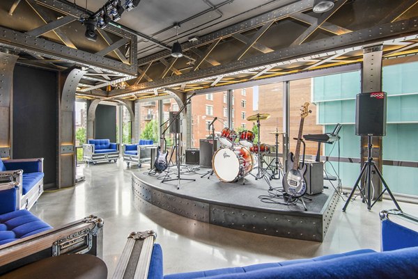 Stage area for performances at Spoke Apartments clubhouse, featuring modern lighting and sound system in a luxury setting