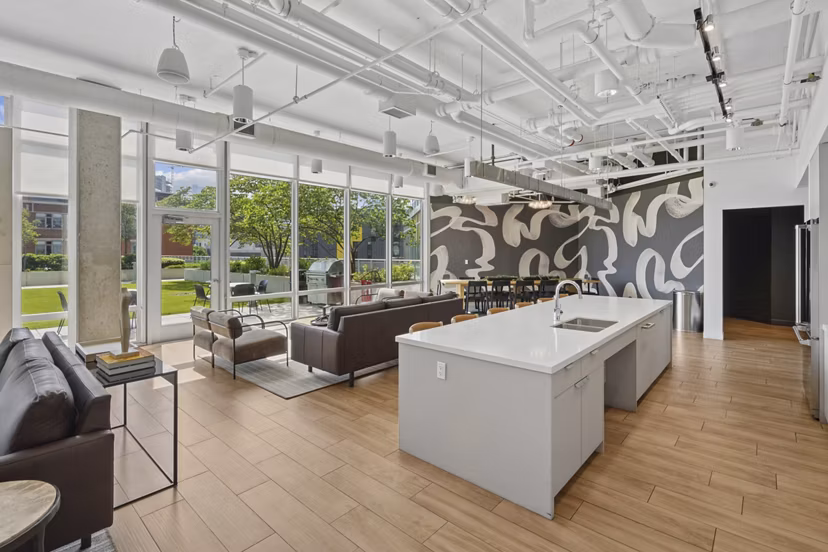 Clubhouse showcasing modern design and lounge seating at Spoke Apartments, luxury living by Greystar in a vibrant community setting