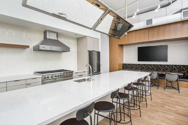 Clubhouse kitchen with modern finishes at Spoke Apartments featuring premium appliances and open layout for residents to enjoy