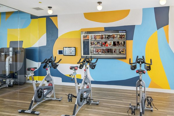 Modern spin studio with state-of-the-art bikes at Spoke Apartments offering luxury fitness amenities