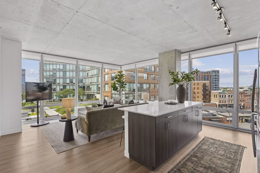Inviting living room with modern decor and large windows at Spoke Apartments in Chicago