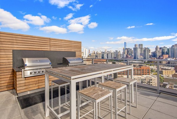 Outdoor grill area and patio at Harvest Apartments, perfect for social gatherings and relaxation in luxury surroundings