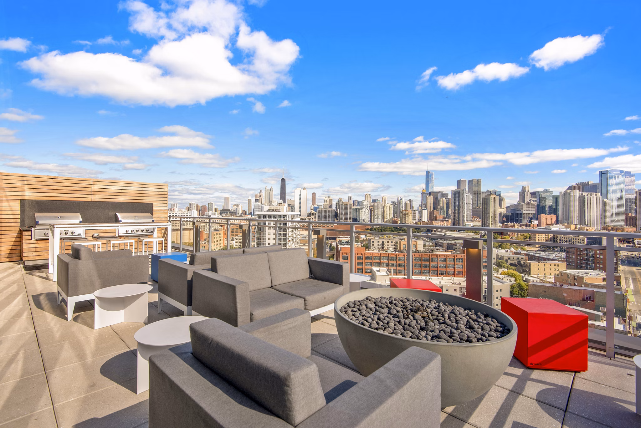 Fire pit and grill area on patio at Harvest Apartments: Luxurious outdoor amenities for relaxation and community gatherings