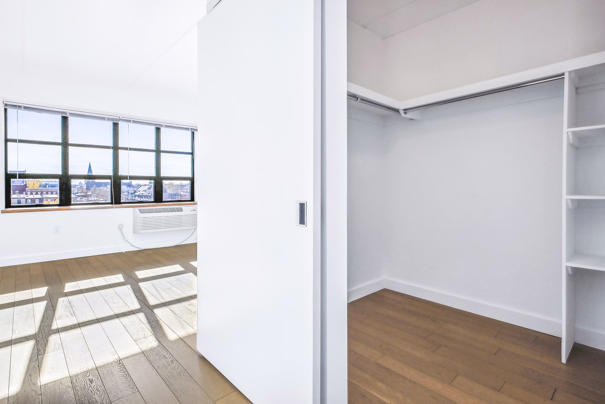 Spacious bedroom closet with custom shelving at Embankment House Apartments