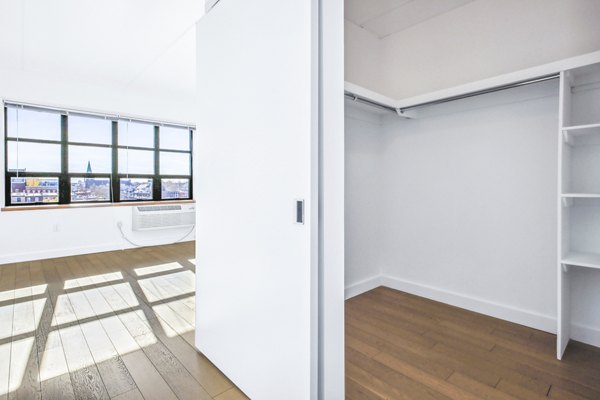 Spacious bedroom closet with custom shelving at Embankment House Apartments