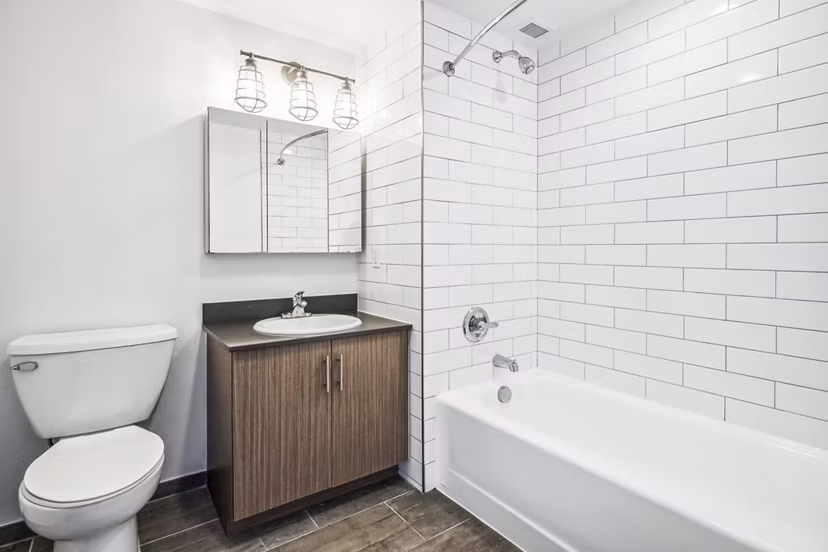 Contemporary bathroom with marble countertops and modern fixtures at Embankment House Apartments, a luxury Greystar property