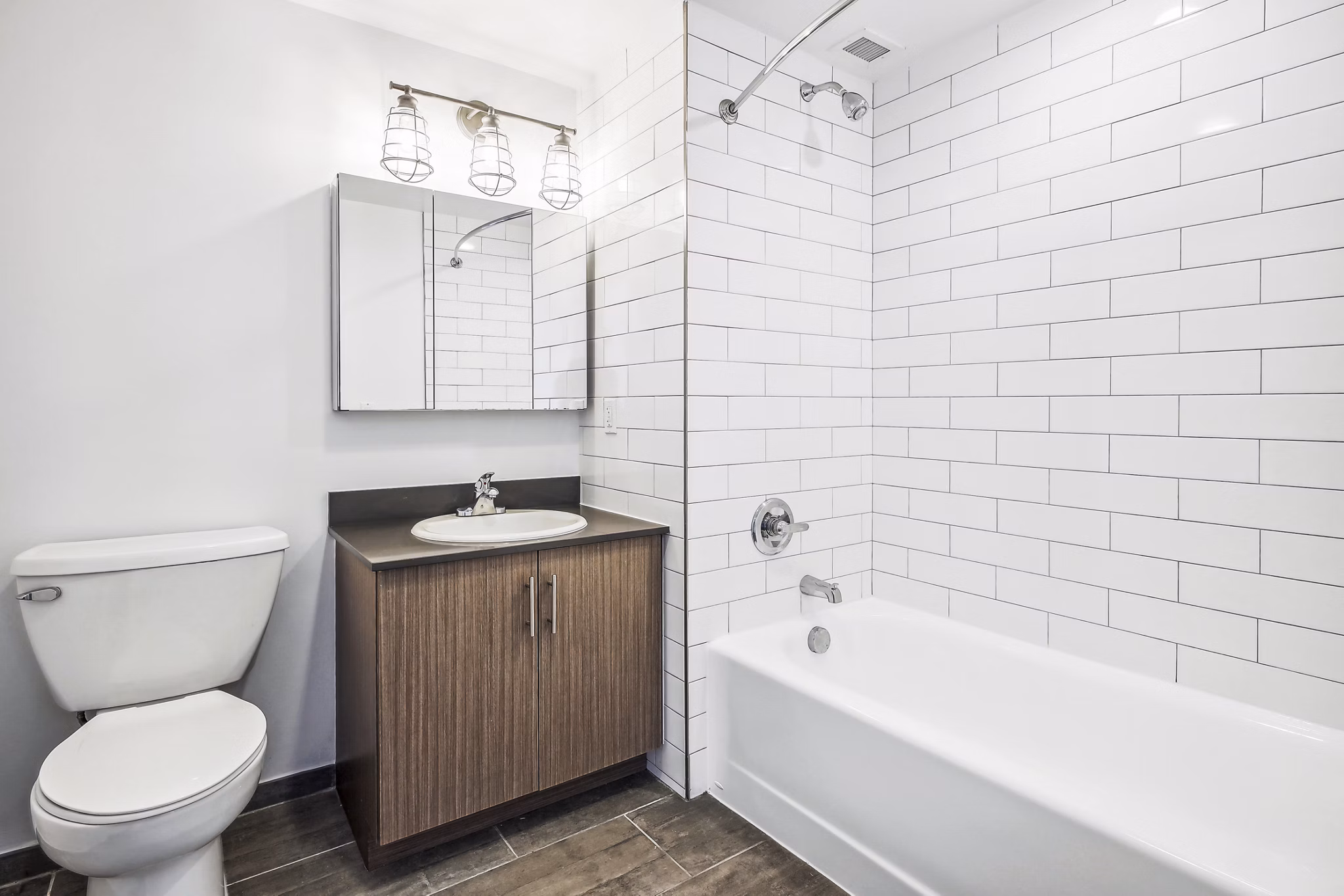 Contemporary bathroom with marble countertops and modern fixtures at Embankment House Apartments, a luxury Greystar property