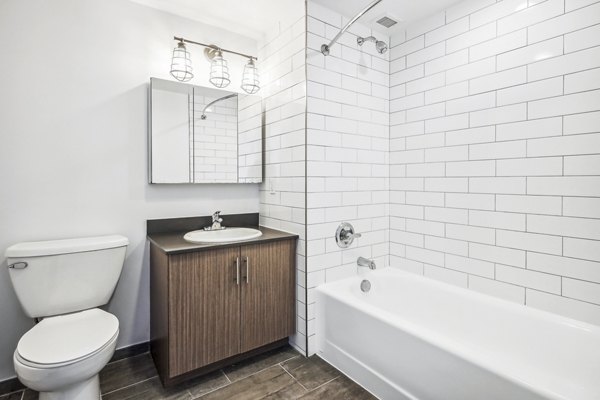 Contemporary bathroom with marble countertops and modern fixtures at Embankment House Apartments, a luxury Greystar property