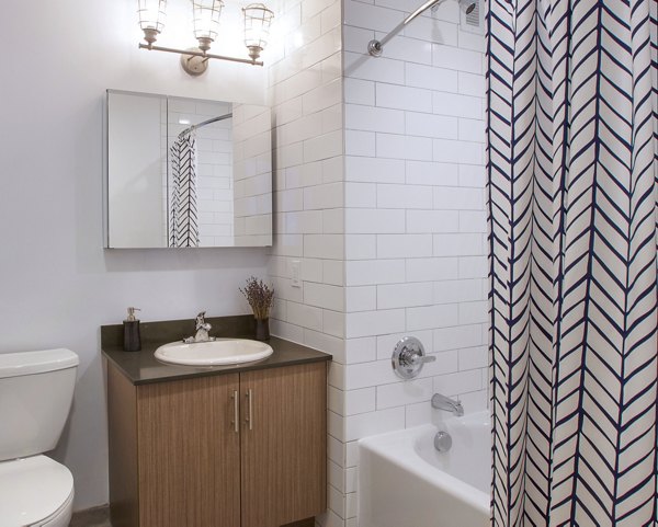 Bathroom featuring modern fixtures and elegant tile design in Embankment House Apartments
