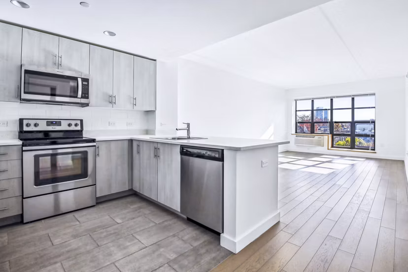Modern kitchen with stainless steel appliances at Embankment House Apartments
