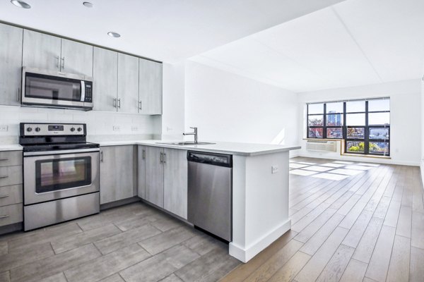 Modern kitchen with stainless steel appliances at Embankment House Apartments