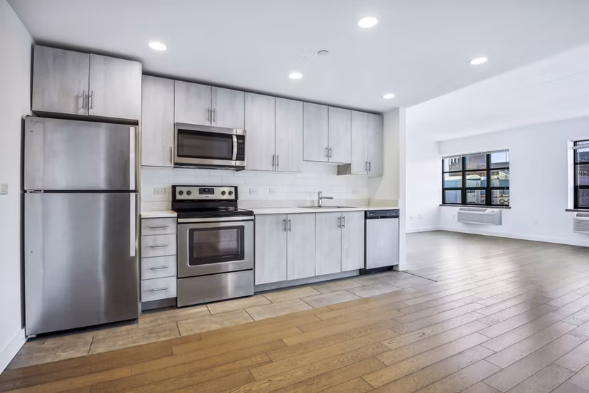 Modern kitchen with stainless steel appliances at Embankment House Apartments, a Greystar luxury apartment community