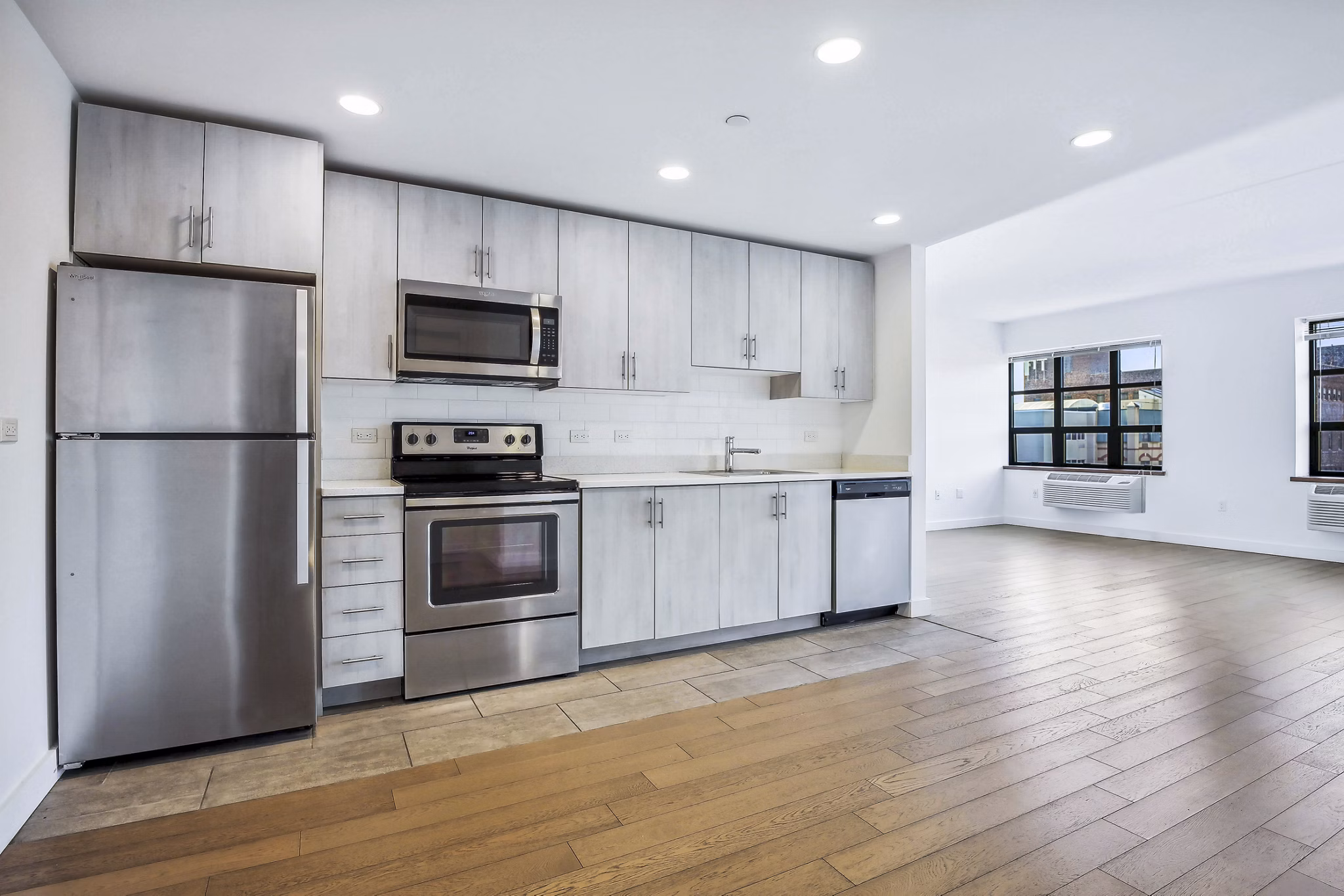 Modern kitchen with stainless steel appliances at Embankment House Apartments, a Greystar luxury apartment community