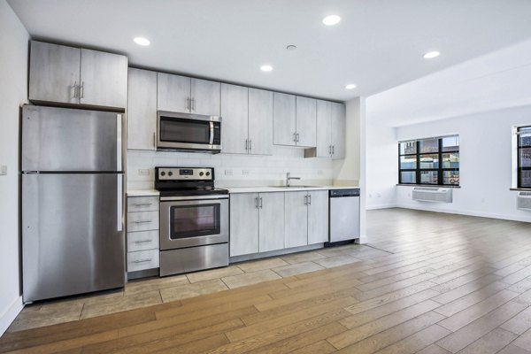 Modern kitchen with stainless steel appliances at Embankment House Apartments, a Greystar luxury apartment community