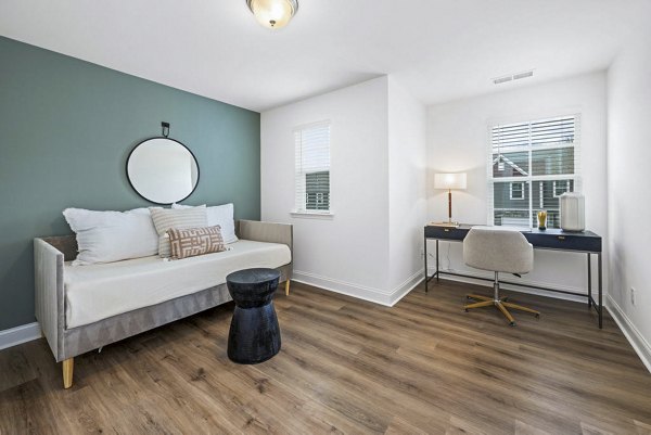 Modern bedroom with cozy home office in Affinity at Kendrick Apartments, a luxury living space by Greystar