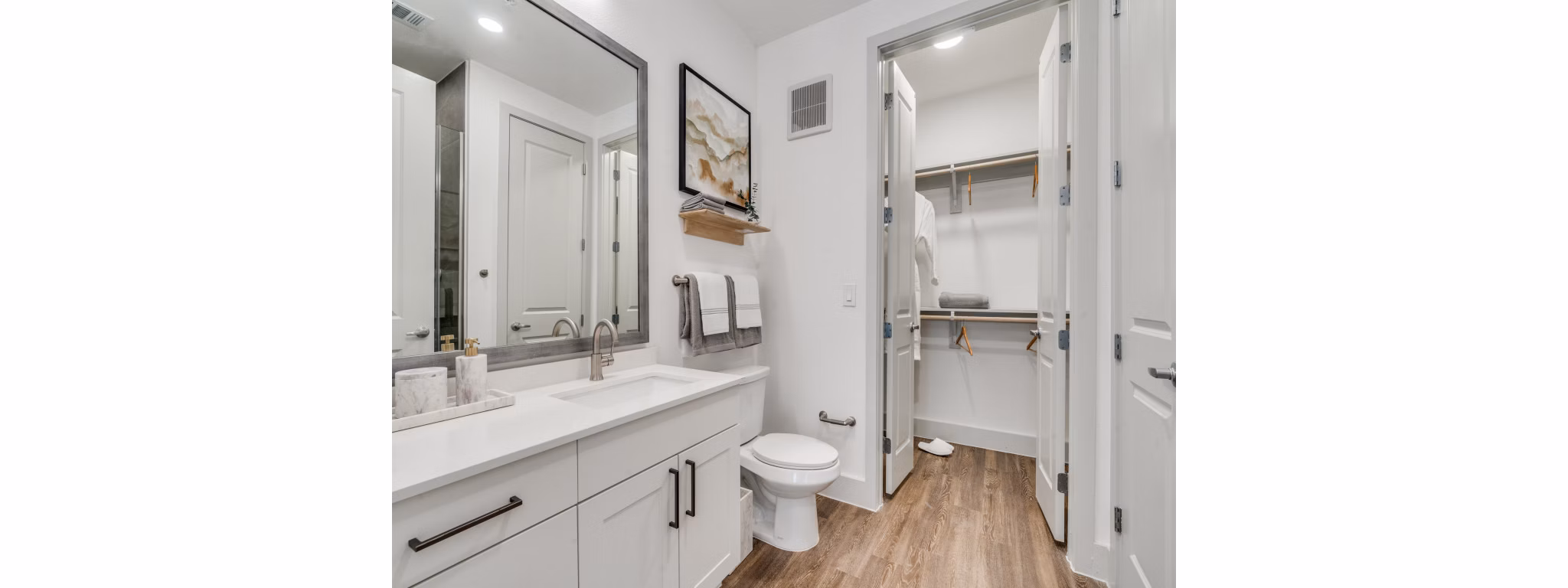 Luxurious bathroom with modern fixtures at The Met Apartments featuring elegant tiling and spacious vanity