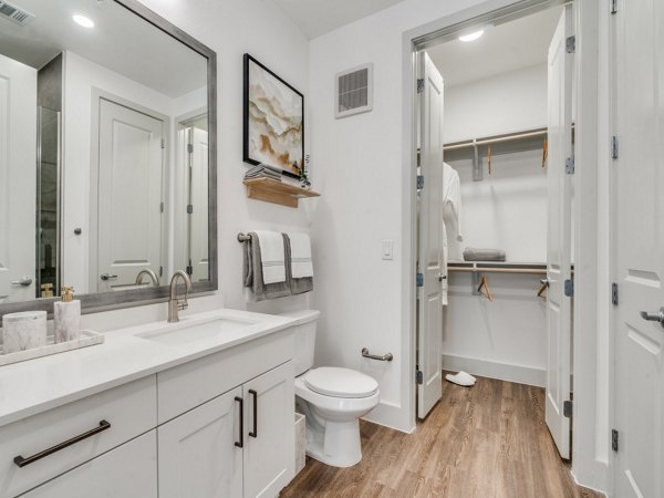 Luxurious bathroom with modern fixtures at The Met Apartments featuring elegant tiling and spacious vanity