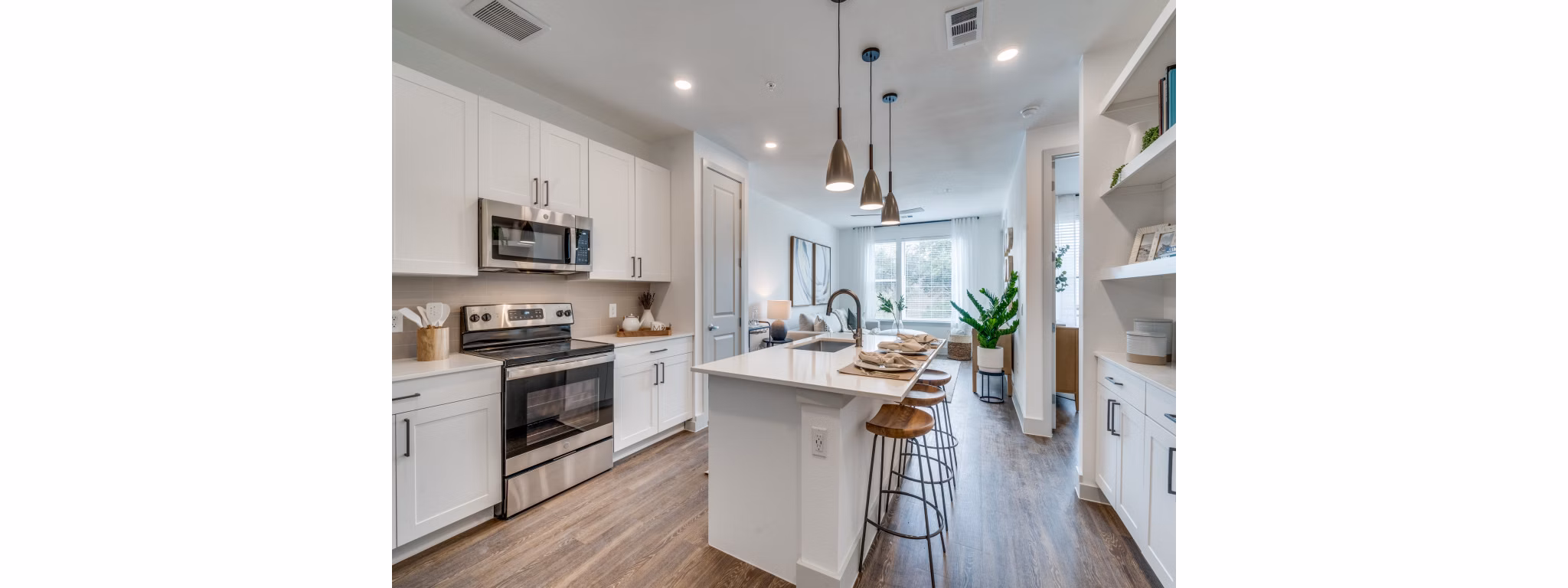 Modern open kitchen with stainless steel appliances at The Met Apartments, a luxurious living space by Greystar
