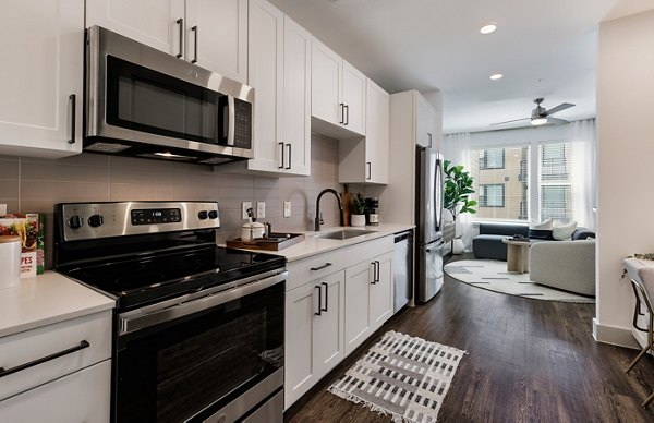 Modern kitchen featuring sleek countertops and stainless steel appliances at The Met Apartments