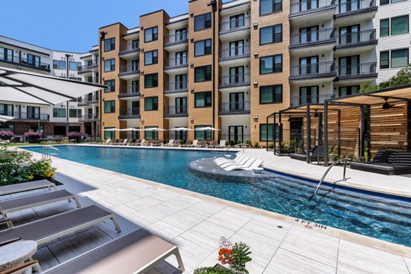 Modern pool area with poolside lounges at The Met Apartments