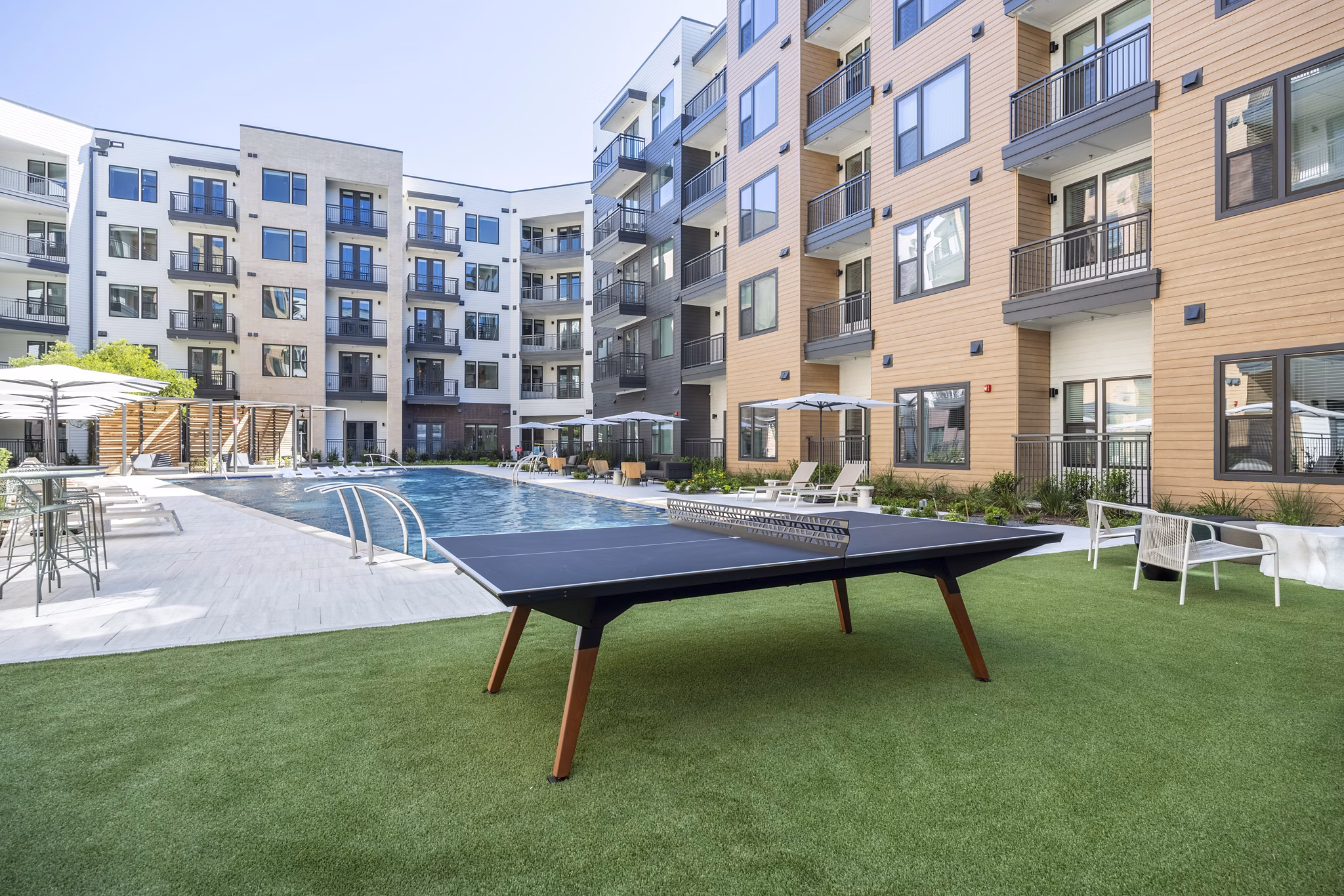 Spacious courtyard featuring lush greenery at The Met Apartments in a luxury setting
