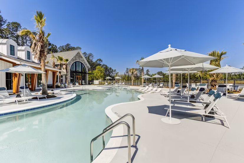 Outdoor pool with sun loungers at Marion Lake Apartments in Greystar community