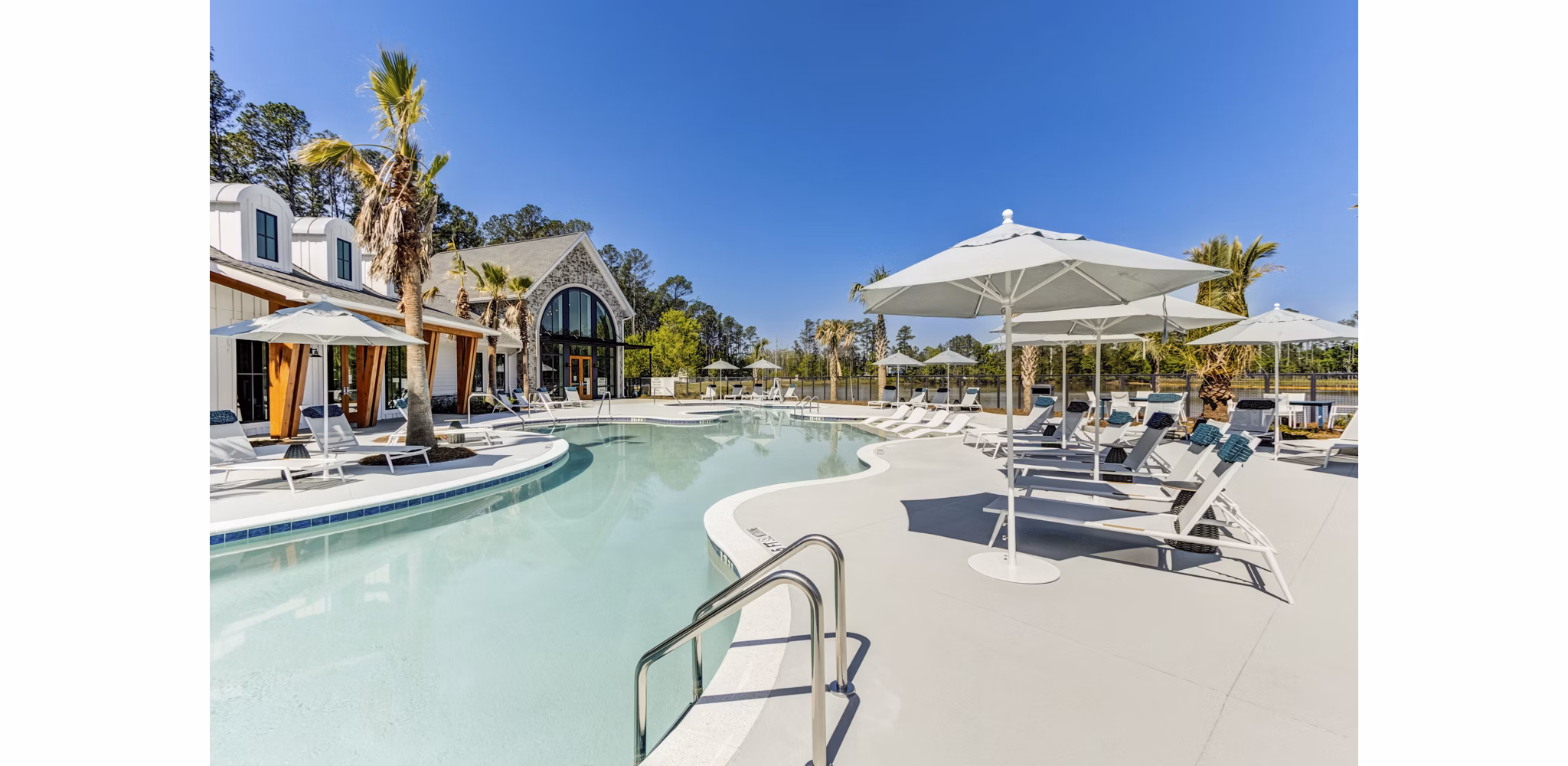 Outdoor pool with sun loungers at Marion Lake Apartments in Greystar community