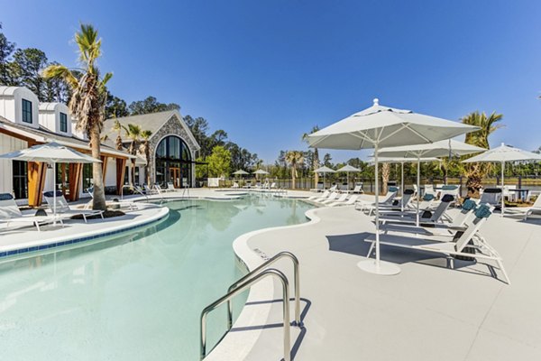 Outdoor pool with sun loungers at Marion Lake Apartments in Greystar community