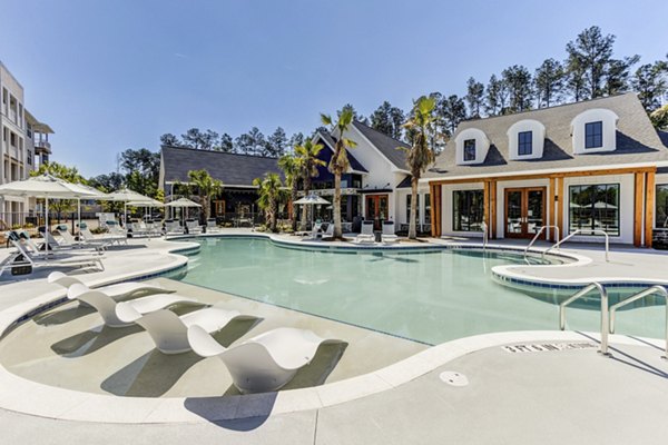 Luxury pool surrounded by lush greenery at Marion Lake Apartments