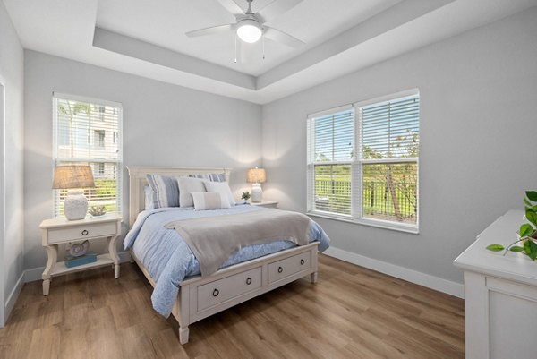 Elegant bedroom with king-size bed and modern decor at Encore at Tradition Apartments, luxury living by Greystar