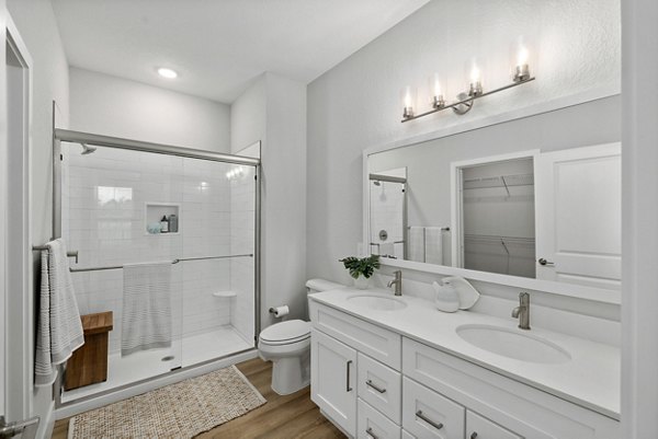 Bathroom with sleek design and modern fixtures in Encore at Tradition Apartments