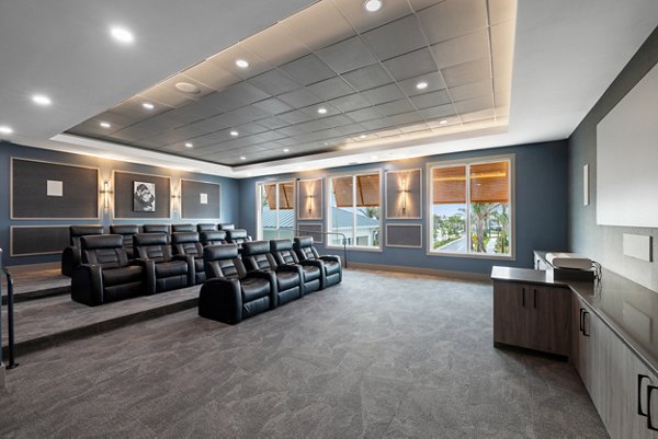 Theater room with plush seating and large screen at Encore at Tradition luxury apartments