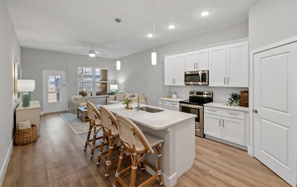 Modern kitchen with sleek appliances and granite countertops at Encore at Tradition Apartments